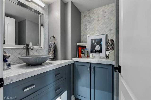 bathroom featuring vanity and backsplash