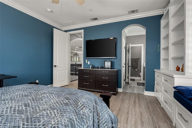 bedroom featuring crown molding, arched walkways, visible vents, and light wood-style flooring