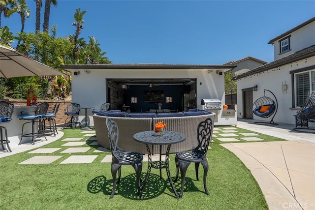 back of property featuring a bar, a patio, stucco siding, an outdoor living space, and a yard