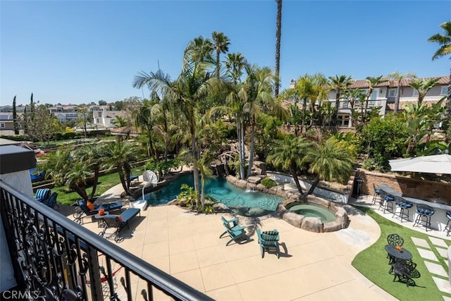 exterior space with a patio and an in ground hot tub