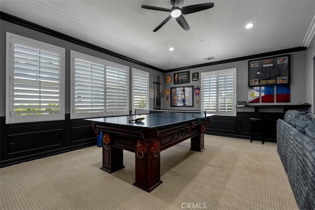 game room featuring crown molding, a decorative wall, plenty of natural light, and carpet flooring