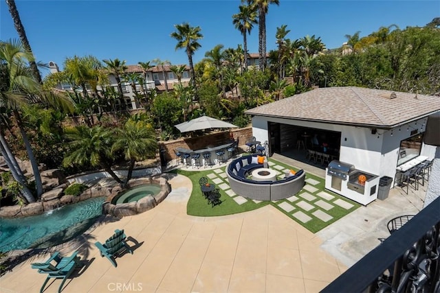 view of patio featuring outdoor dry bar and an in ground hot tub