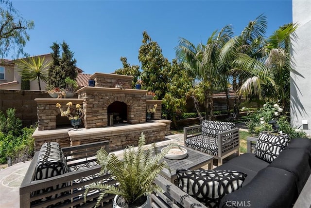 view of patio featuring an outdoor living space with a fireplace