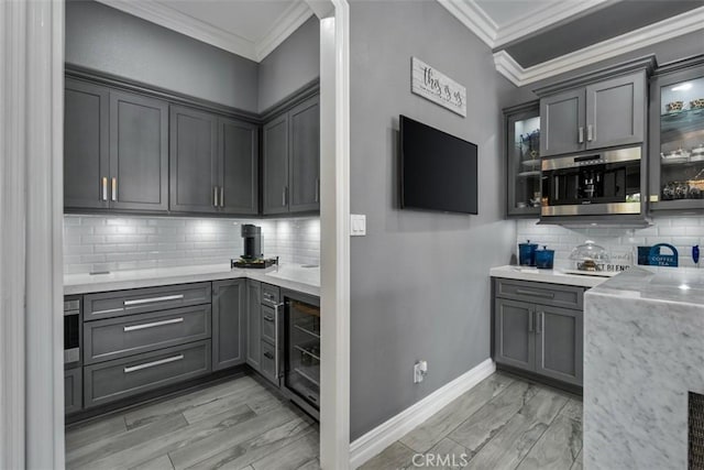 bar with crown molding, beverage cooler, wet bar, light wood finished floors, and backsplash