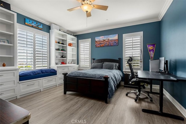 bedroom with light wood-style floors, ornamental molding, and a ceiling fan