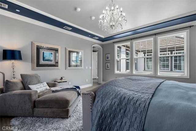 bedroom with arched walkways, baseboards, a chandelier, and multiple windows