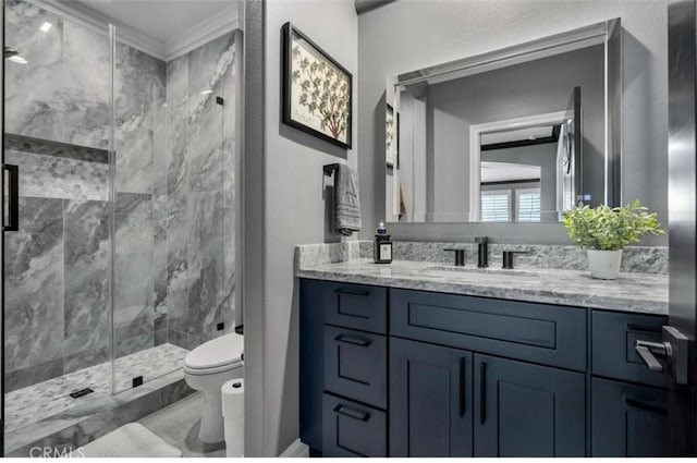 full bath with crown molding, vanity, marble finish floor, toilet, and a marble finish shower