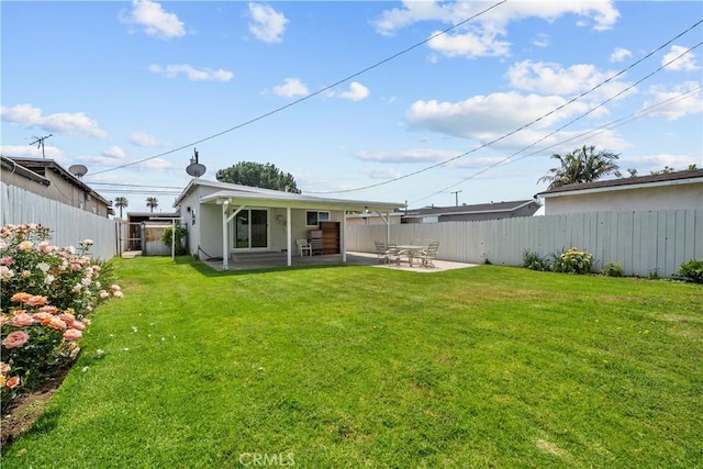 back of house featuring a yard, fence, and a patio area