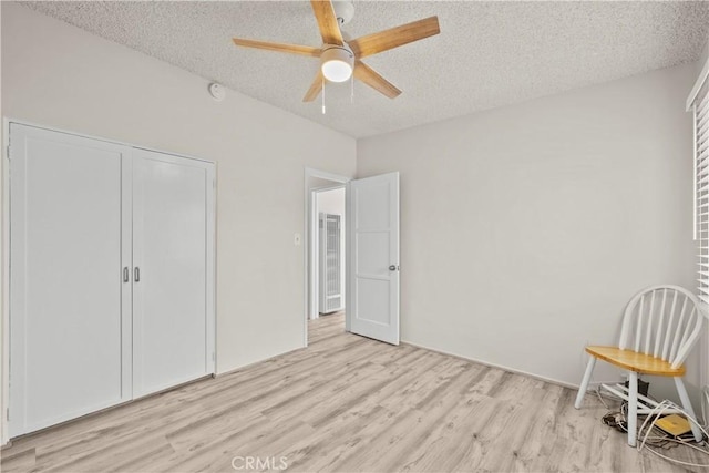 941 N Brand Blvd, San Fernando, CA 91340 - unfurnished bedroom featuring light wood finished floors, a textured ceiling, ceiling fan, and a closet