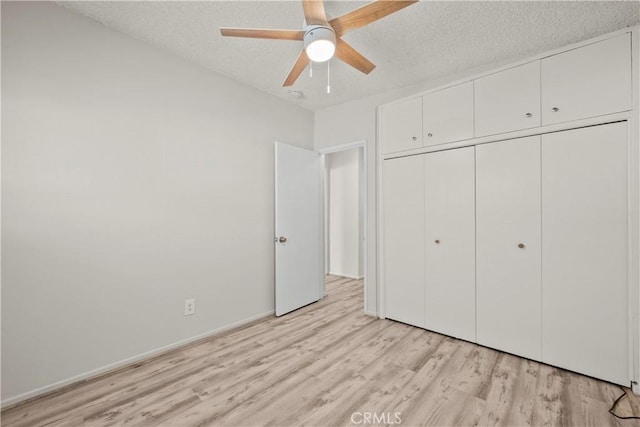 941 N Brand Blvd, San Fernando, CA 91340 - unfurnished bedroom featuring light wood finished floors, a textured ceiling, a closet, and a ceiling fan