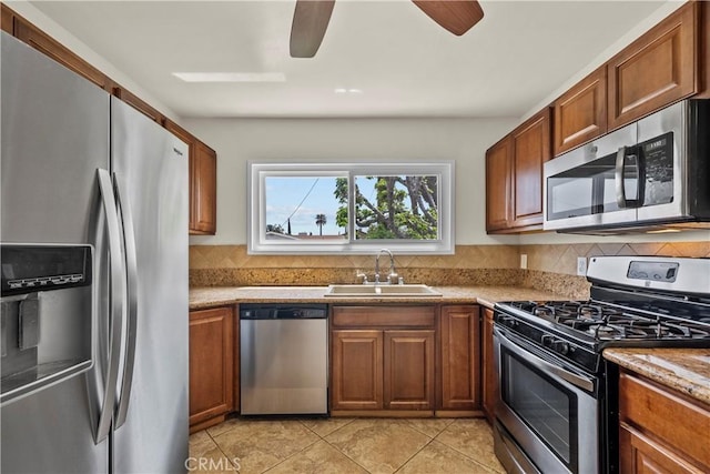 941 N Brand Blvd, San Fernando, CA 91340 - kitchen featuring appliances with stainless steel finishes, backsplash, ceiling fan, and brown cabinetry