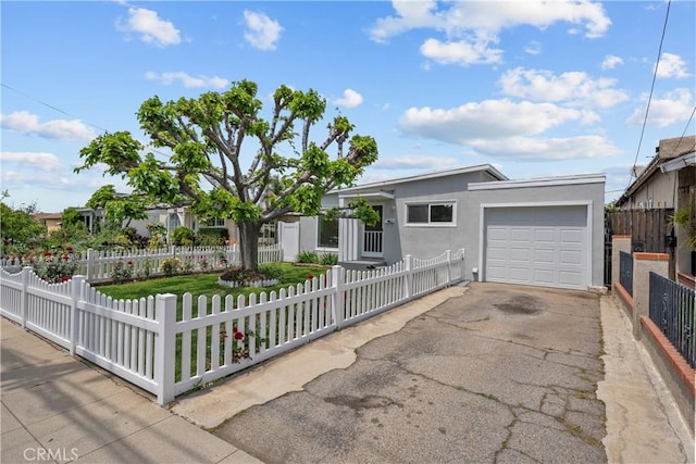 single story home featuring an attached garage, a fenced front yard, stucco siding, and driveway