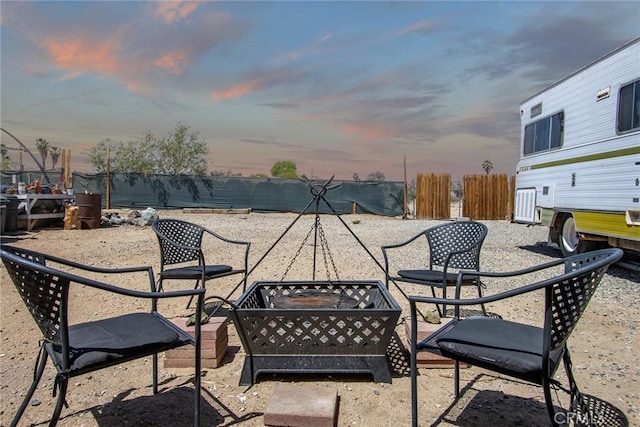 5750 Hall Ln Unit 29, Palms, CA 92277 - patio terrace at dusk with a fenced backyard and a fire pit