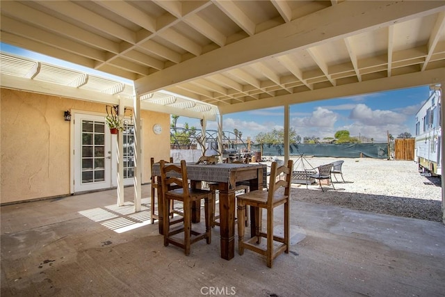 view of patio with fence and outdoor dining area