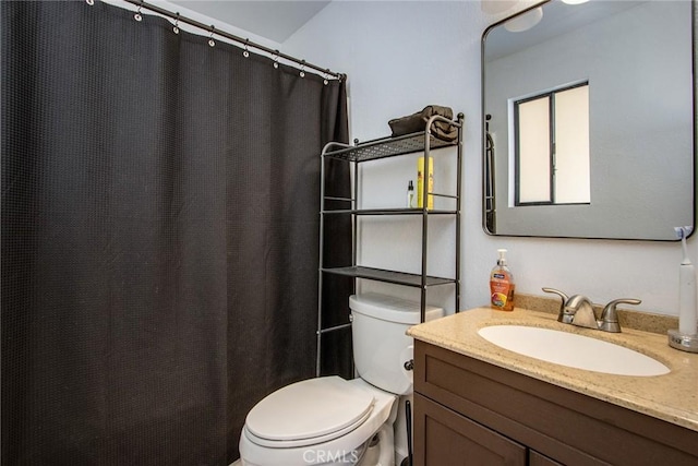 bathroom featuring toilet and vanity