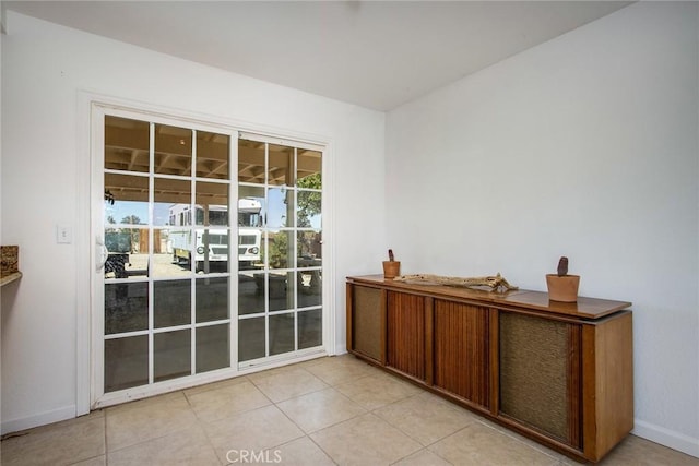 5750 Hall Ln Unit 29, Palms, CA 92277 - doorway to outside with baseboards and light tile patterned floors