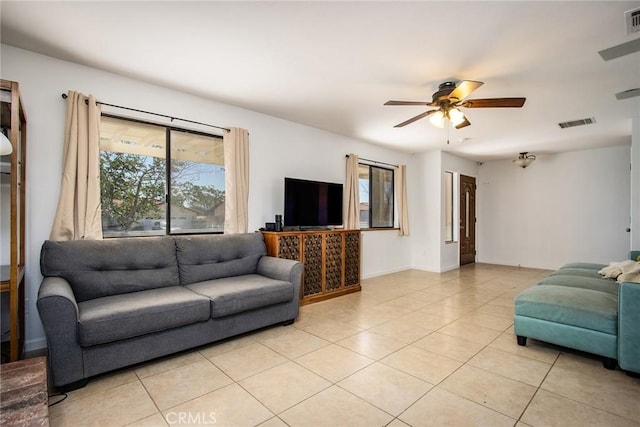 living area with light tile patterned floors, ceiling fan, and visible vents