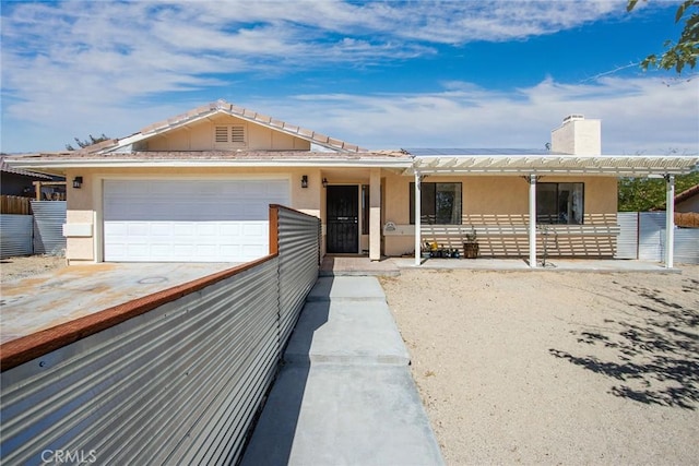single story home featuring fence, stucco siding, a chimney, an attached garage, and driveway