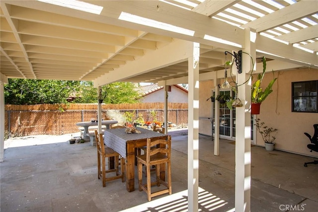 view of patio featuring a pergola, fence, and outdoor dining area