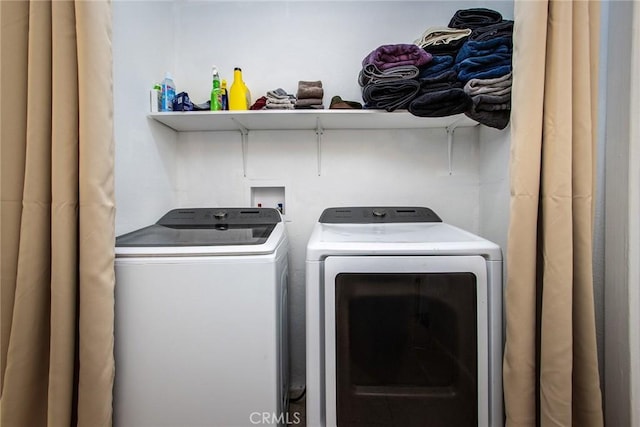 laundry area with washing machine and clothes dryer and laundry area