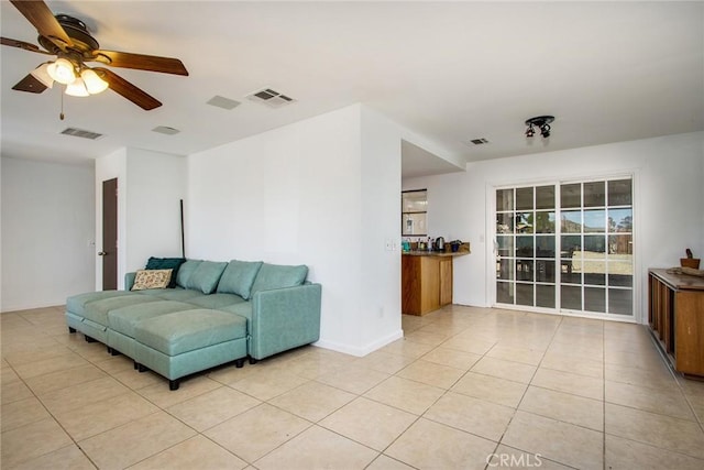 living room with visible vents, a ceiling fan, and light tile patterned flooring
