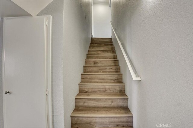 staircase with a textured wall