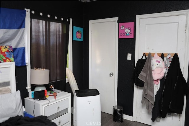 bedroom featuring wood finished floors