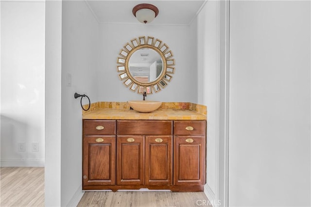 10535 Wilshire Blvd Unit D01, Los Angeles, CA 90024 - bathroom featuring wood finished floors, baseboards, ornamental molding, and vanity