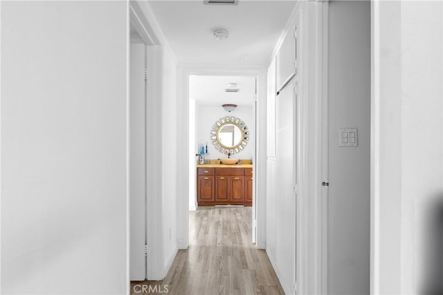 10535 Wilshire Blvd Unit D01, Los Angeles, CA 90024 - hallway with light wood-type flooring and a sink