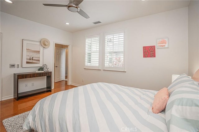 bedroom featuring visible vents, recessed lighting, baseboards, and wood finished floors