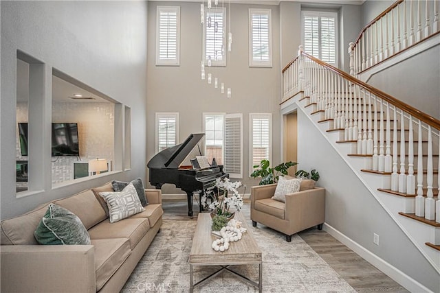 living room featuring stairs, wood finished floors, and a wealth of natural light