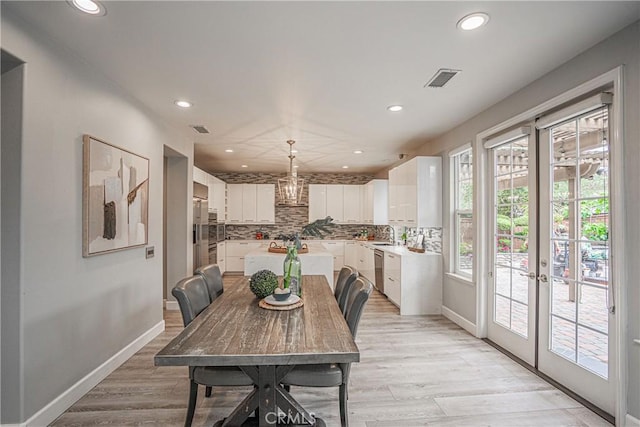 dining space with recessed lighting, baseboards, light wood-style floors, and visible vents