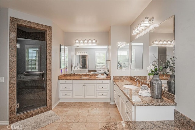bathroom featuring two vanities, a sink, tile patterned flooring, and a stall shower