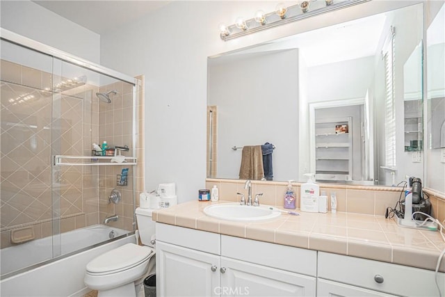 full bath featuring toilet, enclosed tub / shower combo, and vanity