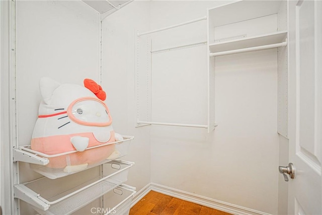 spacious closet with wood finished floors
