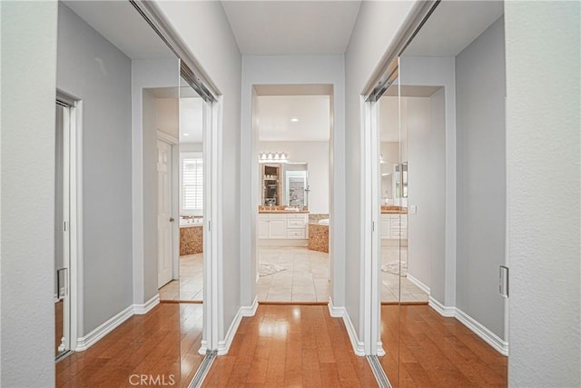 hallway with light wood-style floors