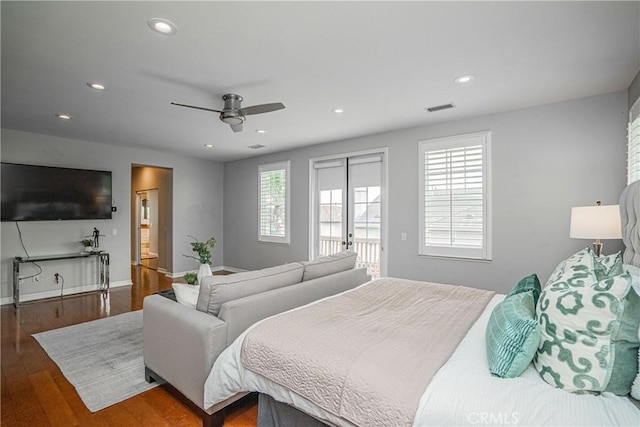 bedroom with baseboards, recessed lighting, wood finished floors, and visible vents