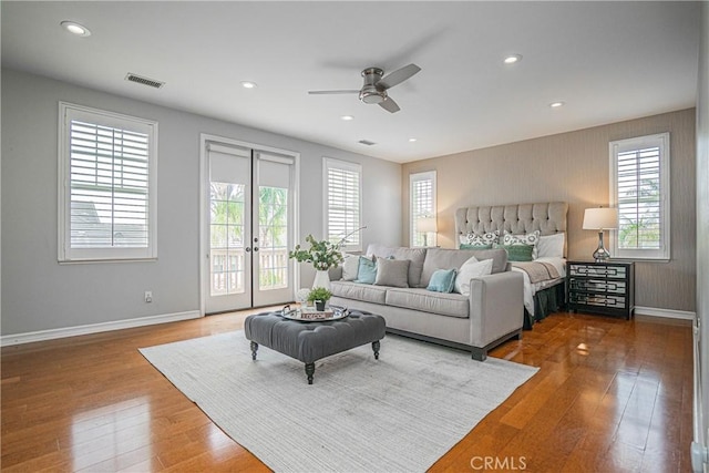 interior space with access to outside, baseboards, visible vents, and multiple windows
