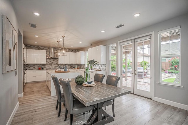 dining space featuring recessed lighting, visible vents, and plenty of natural light