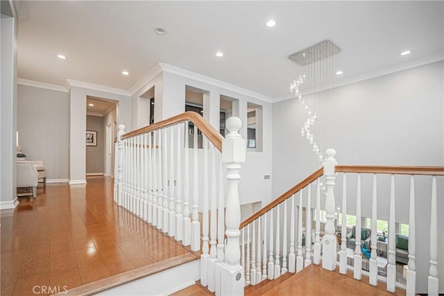 stairs featuring crown molding and recessed lighting