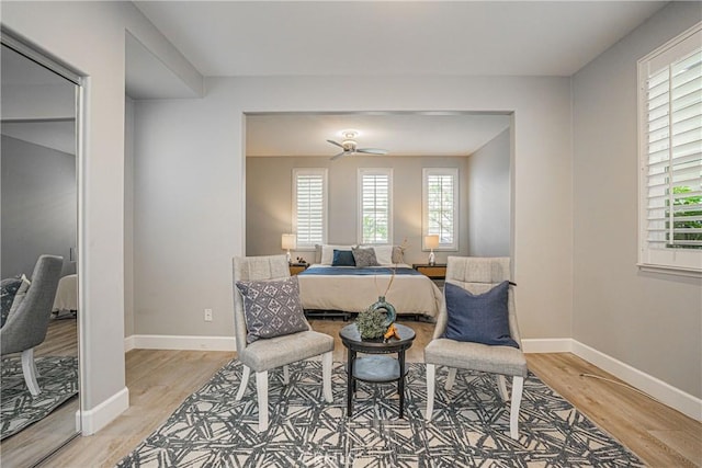dining room featuring baseboards, a ceiling fan, and light wood-style flooring
