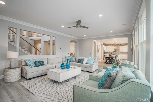 living area with recessed lighting, baseboards, ceiling fan, and light wood finished floors