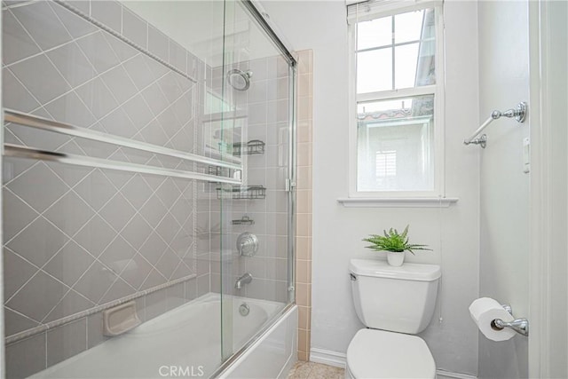 full bath with bath / shower combo with glass door, baseboards, and toilet