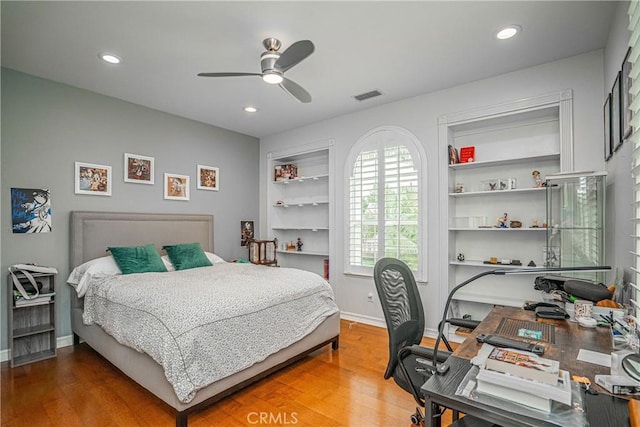 bedroom with a ceiling fan, baseboards, recessed lighting, wood finished floors, and visible vents