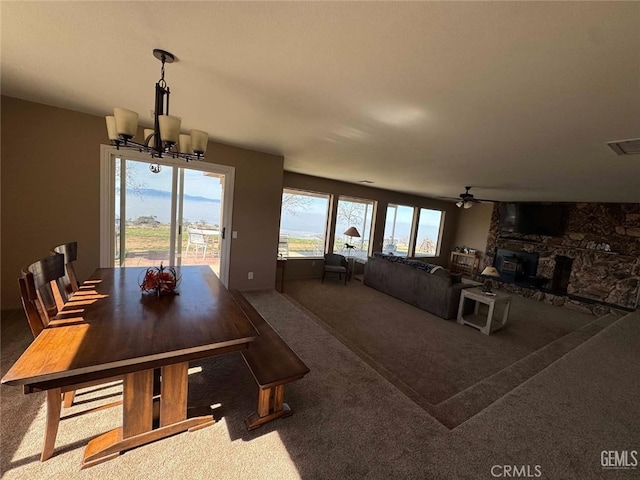 30830 Roan Ct, Tehachapi, CA 93561 - dining room with carpet floors, ceiling fan with notable chandelier, visible vents, and a fireplace