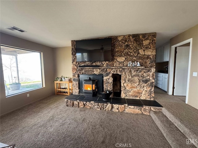 30830 Roan Ct, Tehachapi, CA 93561 - living room with visible vents, a wood stove, baseboards, and carpet flooring