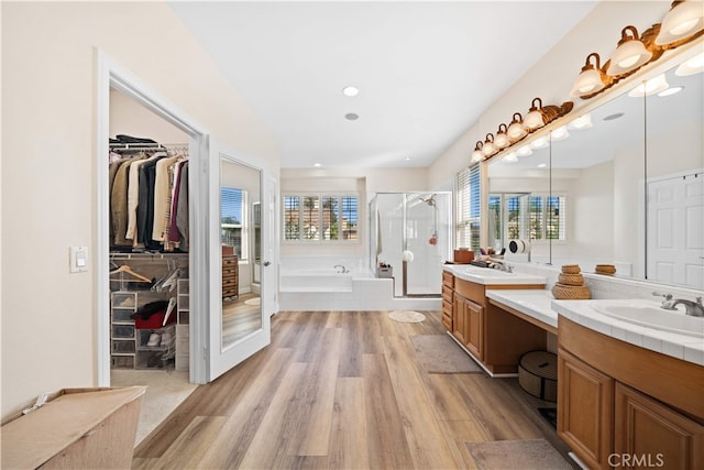 5 Westchester Ct, Coto De Caza, CA 92679 - bathroom with wood finished floors, a stall shower, a garden tub, two vanities, and a walk in closet