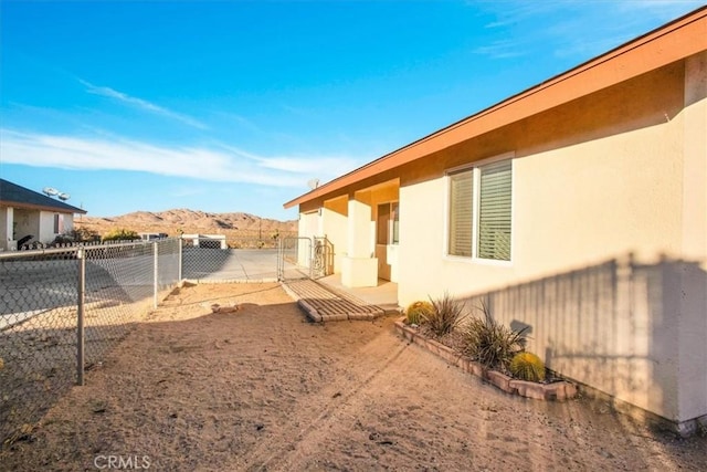 view of yard with a fenced backyard and a mountain view
