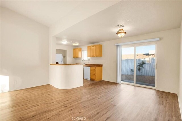 60803 Division St, Joshua Tree, CA 92252 - kitchen featuring white appliances, light wood-style flooring, and healthy amount of natural light