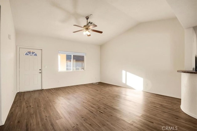 unfurnished living room featuring ceiling fan, vaulted ceiling, wood finished floors, and visible vents
